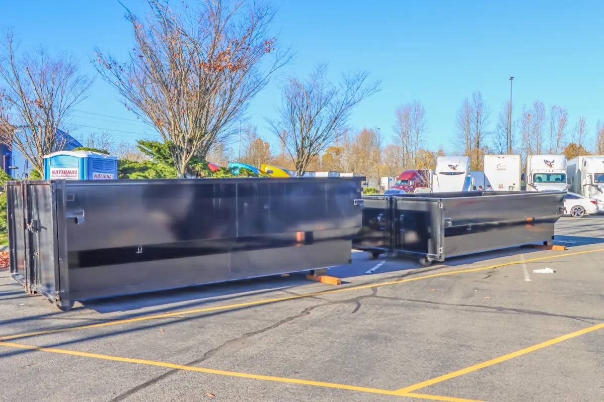 Professional dumpster rental service with roll-off container on residential driveway in Sergeant Bluff